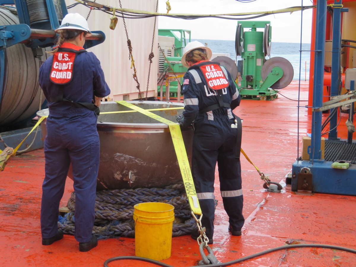 Coast Guard marine safety engineers survey Titan's recovered aft titanium endcap in the North Atlantic, October 4, 2023
